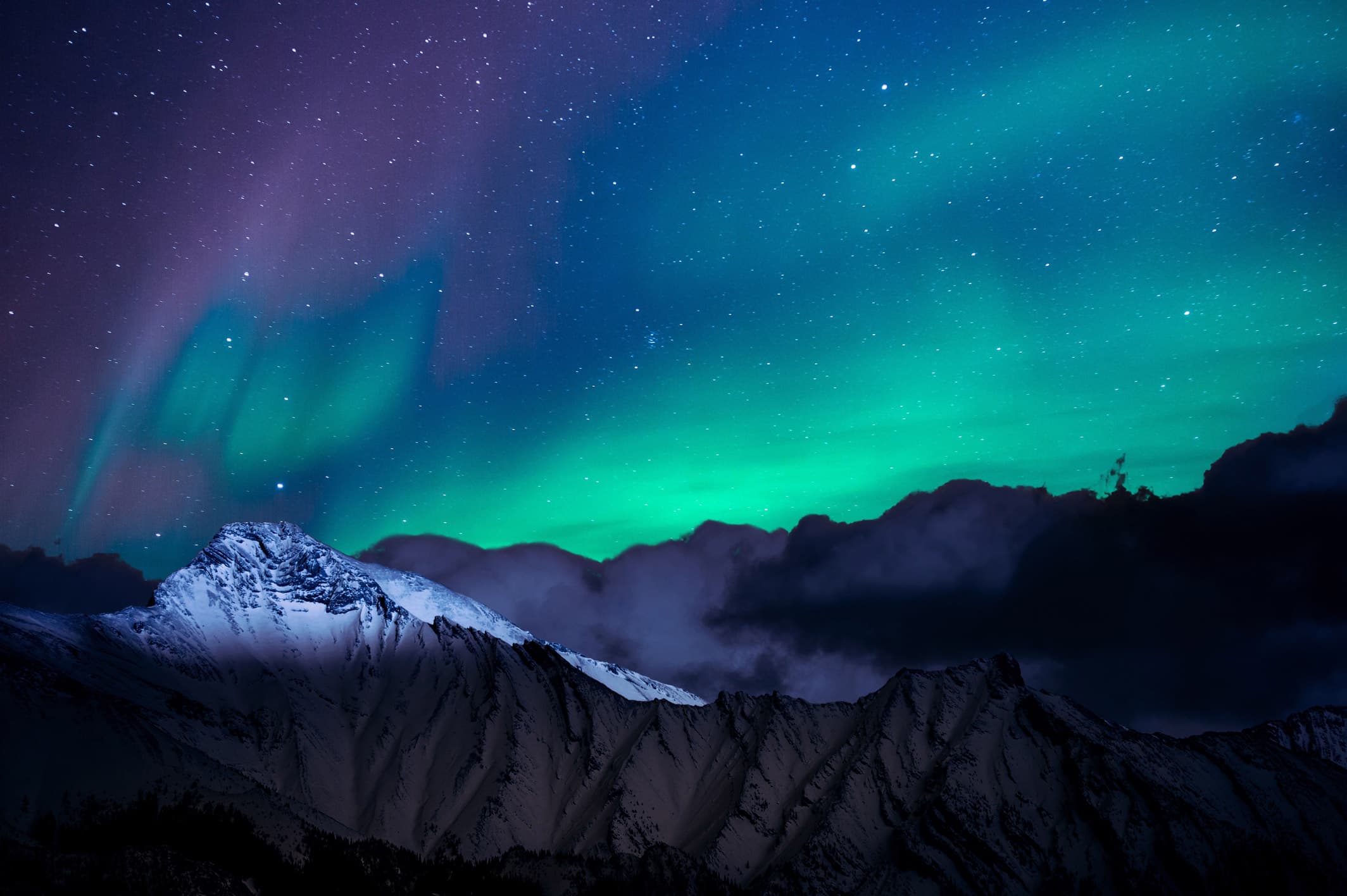 Aurora over a still mountain range