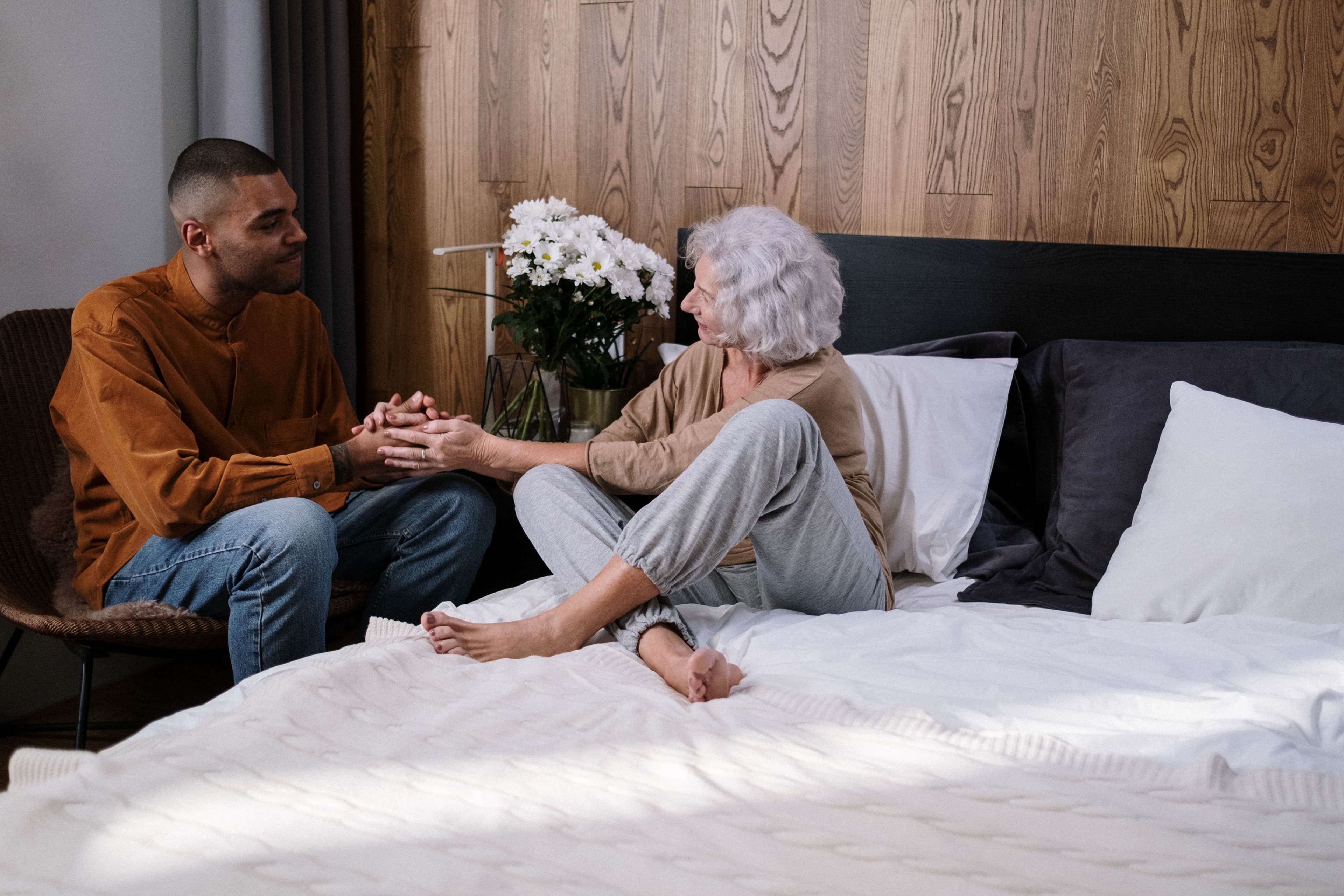 A young man caring for an older woman