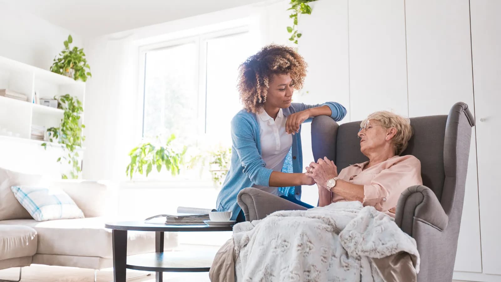 A caregiver gently supporting an elderly resident